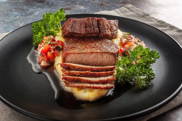 Beef medallions with tomato salsa and cream polenta