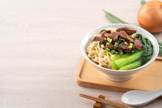 Beef noodle soup Taiwanese famous food in a bowl on wooden table