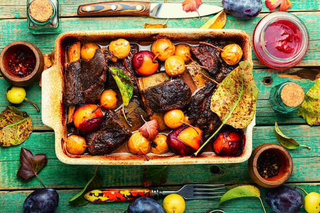 Beef ribs baked in plums and pears.Spicy meat ribs in fruit sauce