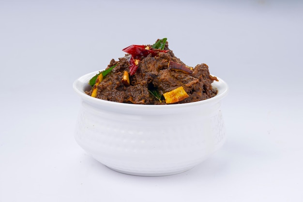 Beef roast masala or curry homemade recipe arranged in white bowl  with white background