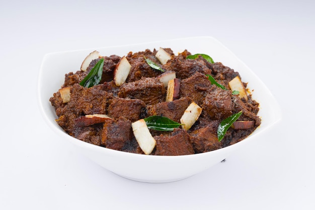 Beef roast masala or curry homemade recipe arranged in white bowl  with white background