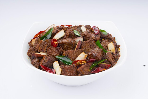 Beef roast masala or curry homemade recipe arranged in white bowl  with white background