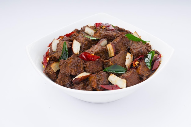 Beef roast masala or curry homemade recipe arranged in white bowl  with white background