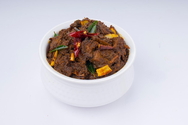 Beef roast masala or curry homemade recipe arranged in white bowl  with white background