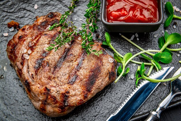 Beef rump steak on black stone table