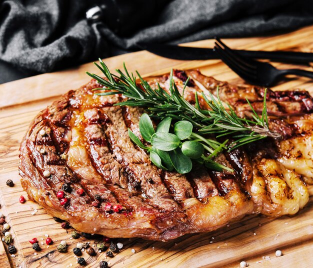 Beef rump steak on wooden table