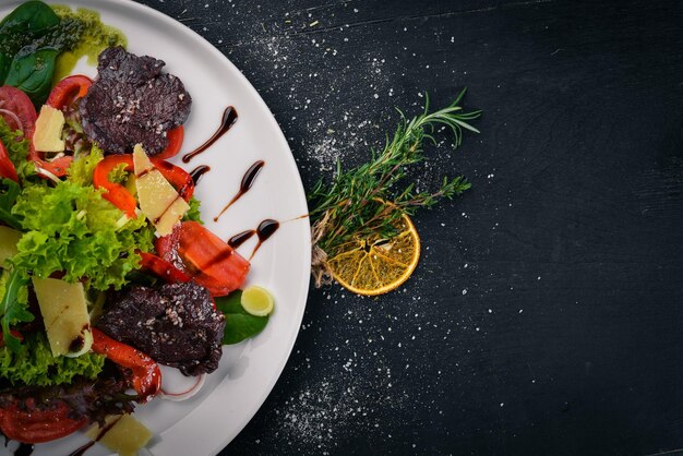 Beef Salad and Fresh Vegetables On a wooden surface Top view Free space for your text