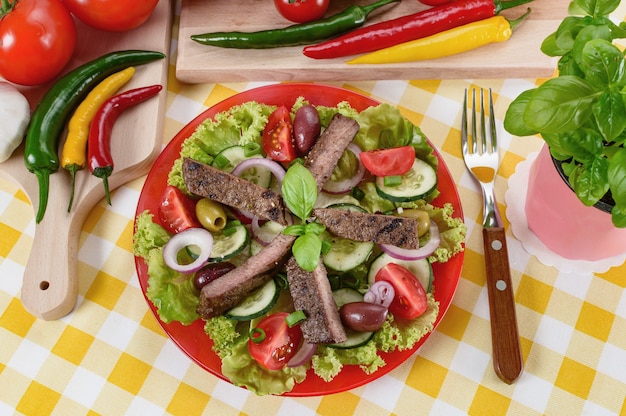 Beef salad on the plate. Grilled beef meat with tasty selection of vegetables.