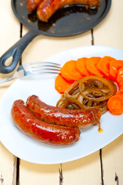 Beef sausages cooked on iron skillet