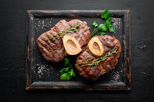 Beef shank roasted on a grill on a wooden background Top view Free space for your text