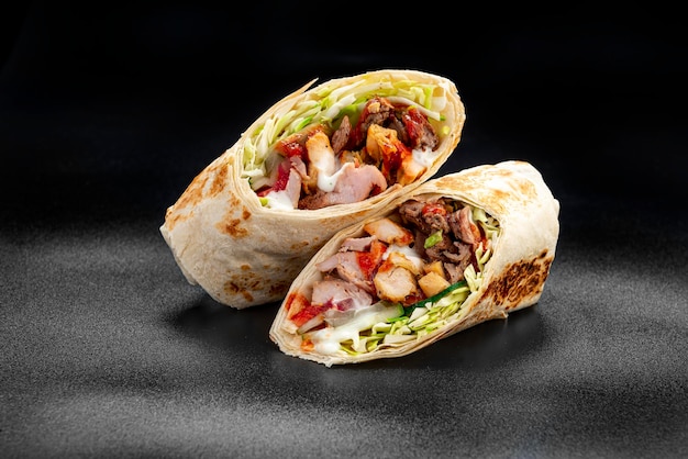 Beef shawarma on a dark background Shawarma with beef in pita bread