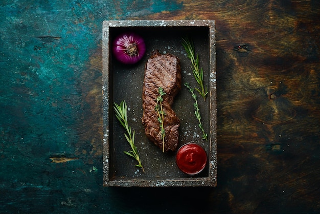 Beef Sirloin steak Juicy cooked steak with rosemary and spices Top view Rustic style Flat Lay