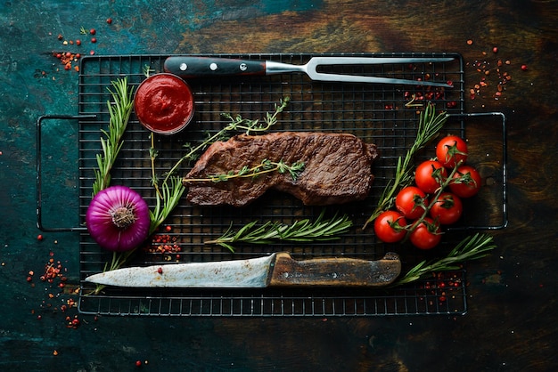 Beef sirloin steak juicy cooked steak with rosemary and spices\
top view rustic style flat lay