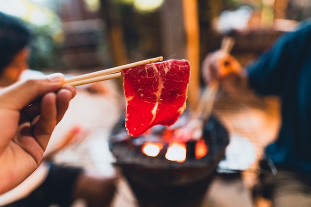 Beef slices grilled on the charcoal stove at home.