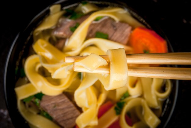 Beef soup with noodles in the Asian style