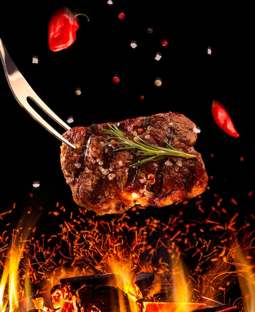 Beef steak falling on the grill with fire. Brazilian barbecue.