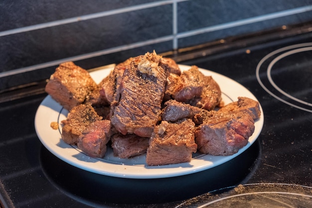 Beef steak slices with garlic on white plate