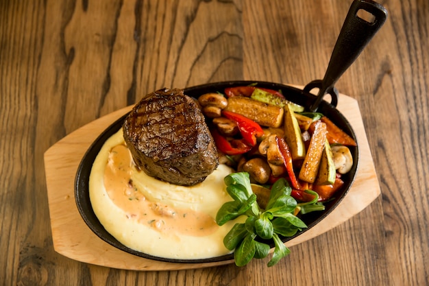 Beef steak with mashed potatoes and grilled vegetables