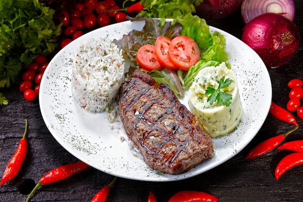 Beef steak with potatoes and rice in isolated white background