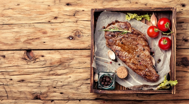 Beef steak on a wooden background