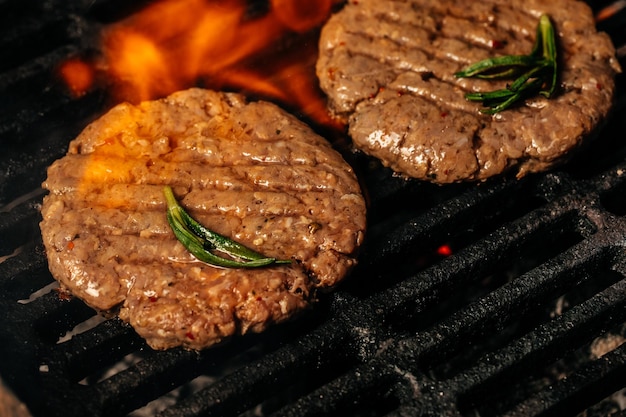 Beef steaks pieces of meat on the grill with flames American cuisine The concept cooking meat Food recipe background Close up place for text