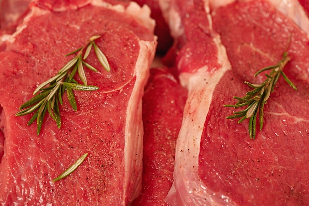 Beef steaks with rosemary closeup Fresh meat