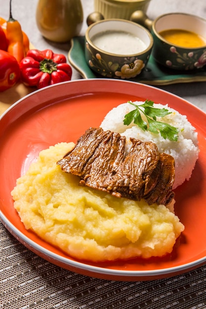 Beef stew mashed potatoes rice Traditional comfort food peruvian cuisine gastronomy