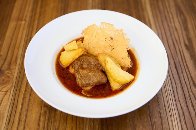 beef stew with potatoes and Parmesan cheese