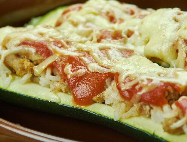 Beef Stuffed Zucchini Boats  , Zucchini halves are filled with ground chicken and provolone cheese, then topped with Parmesan cheese