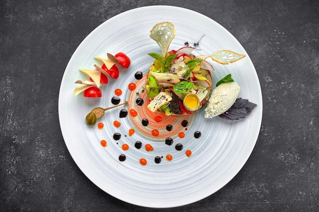 Beef tartare with asparagus and tomatoes on a plate