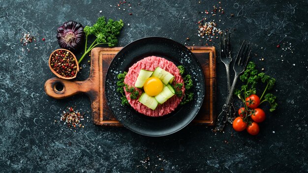 Beef tartare with egg yolk Traditional cuisine Top view Free space for your text