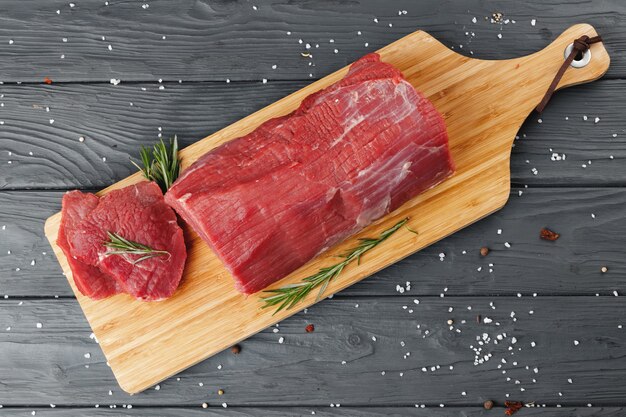 Beef tenderloin on wooden board on wooden table