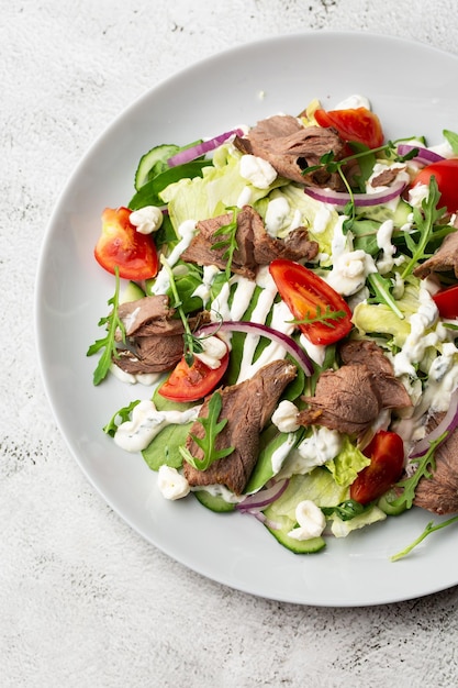 Beef tongue salad with fresh vegetables Serving food in a restaurant Photo for the menu