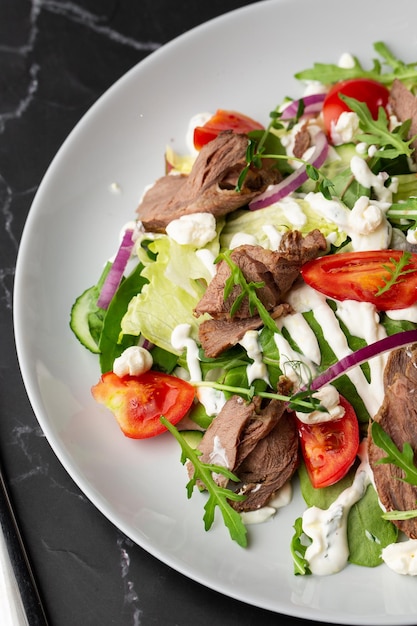 Beef tongue salad with fresh vegetables Serving food in a restaurant Photo for the menu