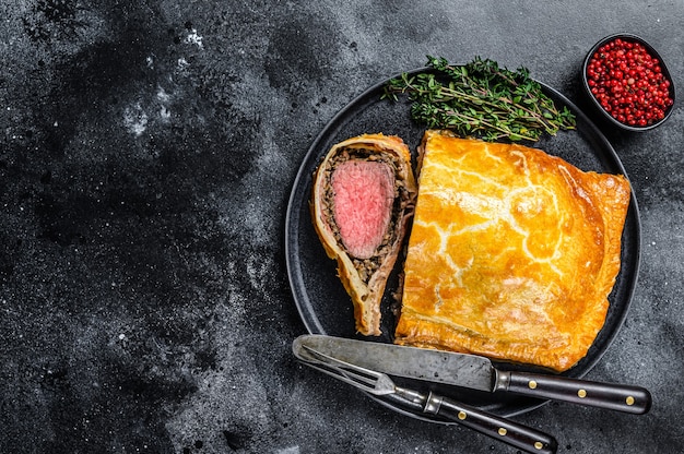 Beef Wellington classic steak dish with tenderloin meat on a plate.