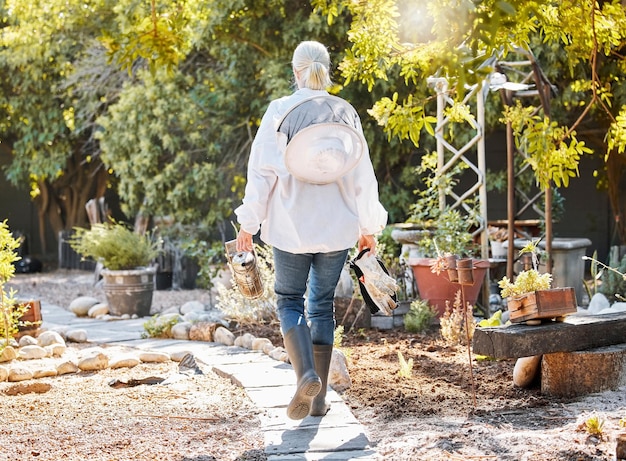 Beekeeping smoke for bees and woman in garden walking with farming equipment gear and protective suit Agriculture nature and senior lady ready to harvest natural organic and fresh honeycomb