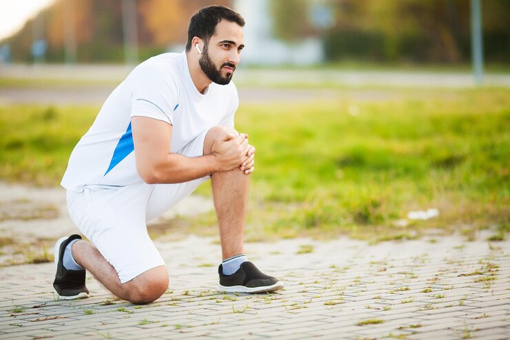 Beenblessure. Mannelijke atleet die lijdt aan pijn in het been tijdens het sporten buitenshuis.