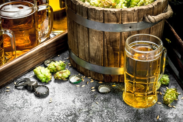 Beer background. Fresh beer with ingredients. On a rustic background.