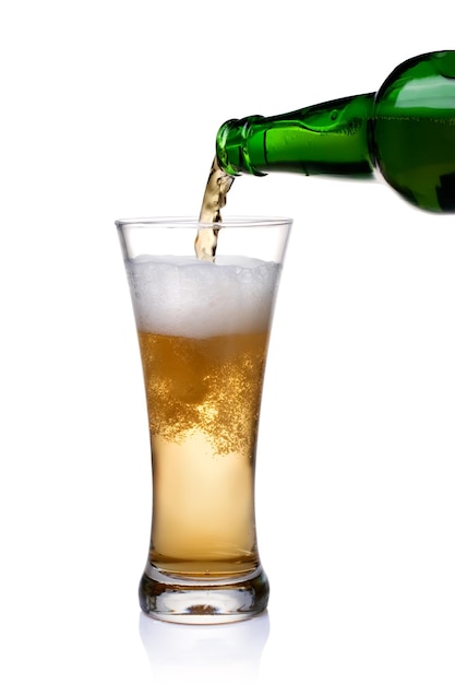 Beer being pour on a glass over a white background