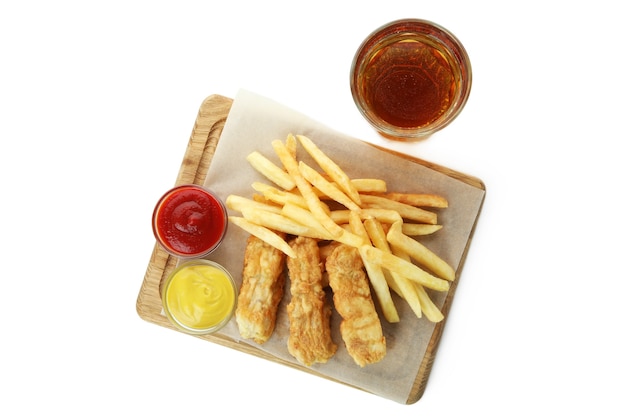 Beer and board with fried fish and chips and sauces isolated