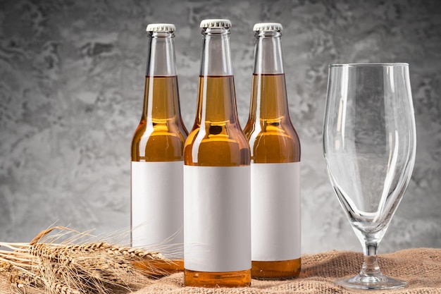 Beer bottle and beer glass against gray background