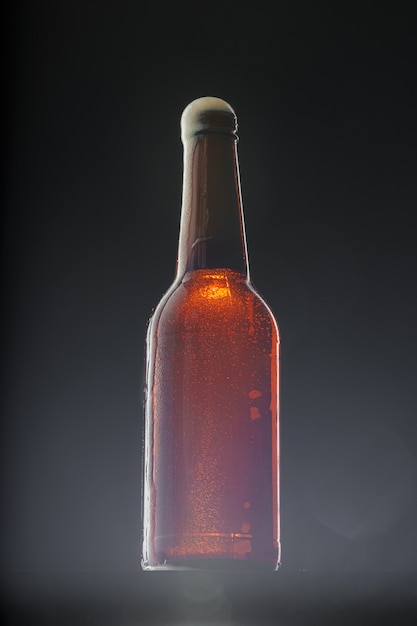 Photo beer bottle on dark background, copy space
