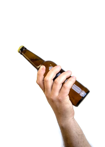 Beer bottle in hand isolated on white