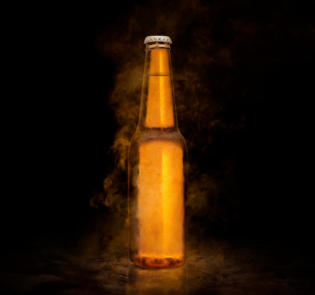 Beer bottle with water drops on the brown color smoke black background