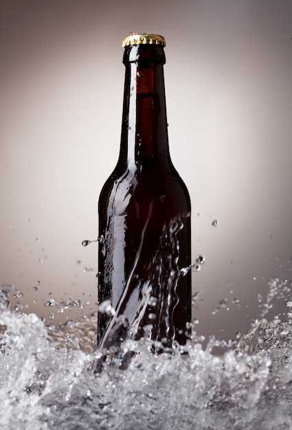 Beer bottle with water splash