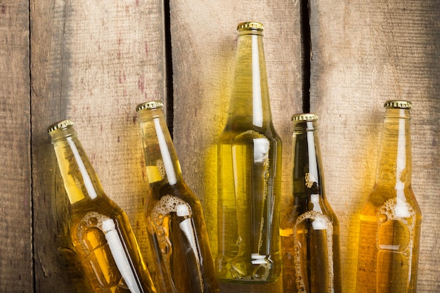 Beer bottles on a wooden table .