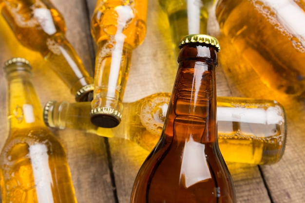 Beer bottles on a wooden table .