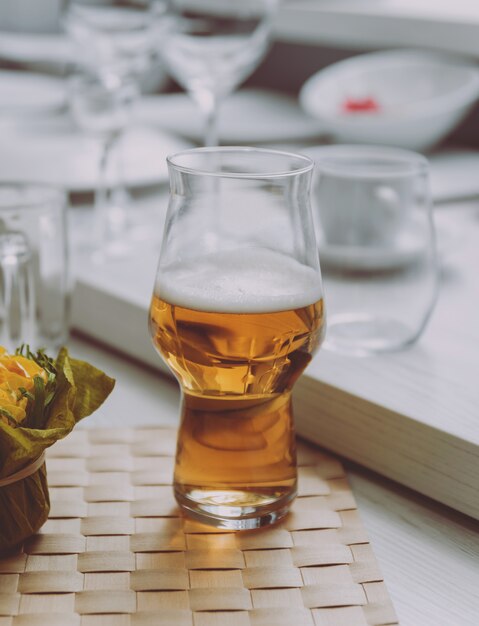 Beer and chips on a large white table