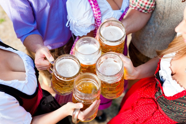 In Beer garden - friends drinking beer