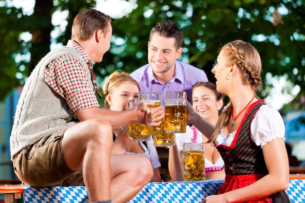 In Beer garden - friends drinking beer